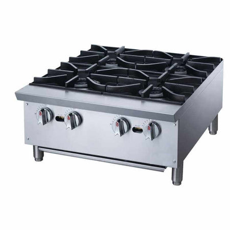 a commercial gas stove with four burners